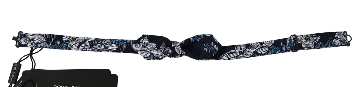 Elevate your style with the Dolce & Gabbana Navy Blue Floral Slim Adjustable Neck Papillon Bow Tie, a luxurious silk accessory that embodies timeless elegance and sophistication.