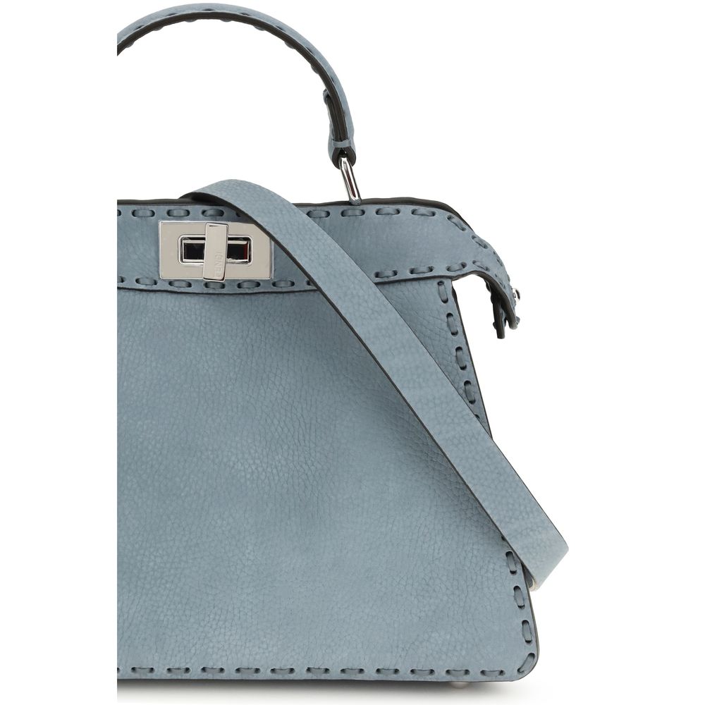 Indulge in the Fendi Light Blue Calf Leather Bos Taurus Handbag, a testament to exquisite craftsmanship and timeless elegance, perfect for elevating any ensemble.