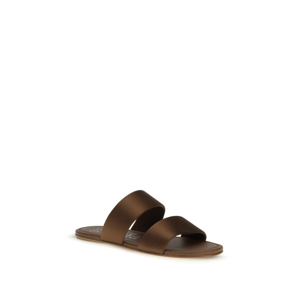Step into a realm of elegance with Pedro García's Brown Silk Flat Sandals, where luxurious silk and refined craftsmanship elevate your style for any occasion.