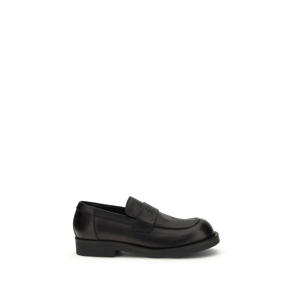 Experience the opulent allure of MM6 Black Calf Leather Bos Taurus Slip-On Loafers, where indulgent craftsmanship meets timeless elegance for the discerning individual.