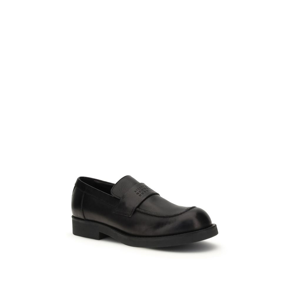 Indulge in the MM6 Black Calf Leather Bos Taurus Slip-On Loafers, where exquisite craftsmanship meets timeless elegance, perfect for the discerning individual.