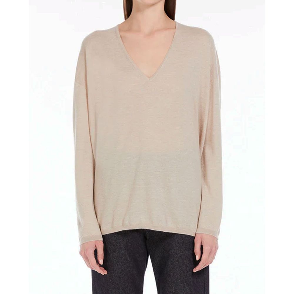 Discover the Max Mara Beige Cashmere Sweater, a masterpiece of 100% cashmere that embodies timeless elegance and unparalleled comfort for the discerning individual.