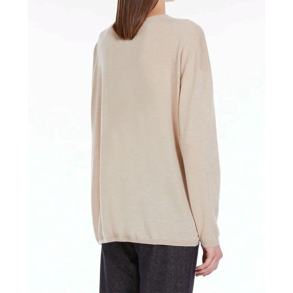 Experience the exquisite allure of the Max Mara Beige Cashmere Sweater, a 100% cashmere masterpiece that embodies timeless elegance and luxurious comfort.