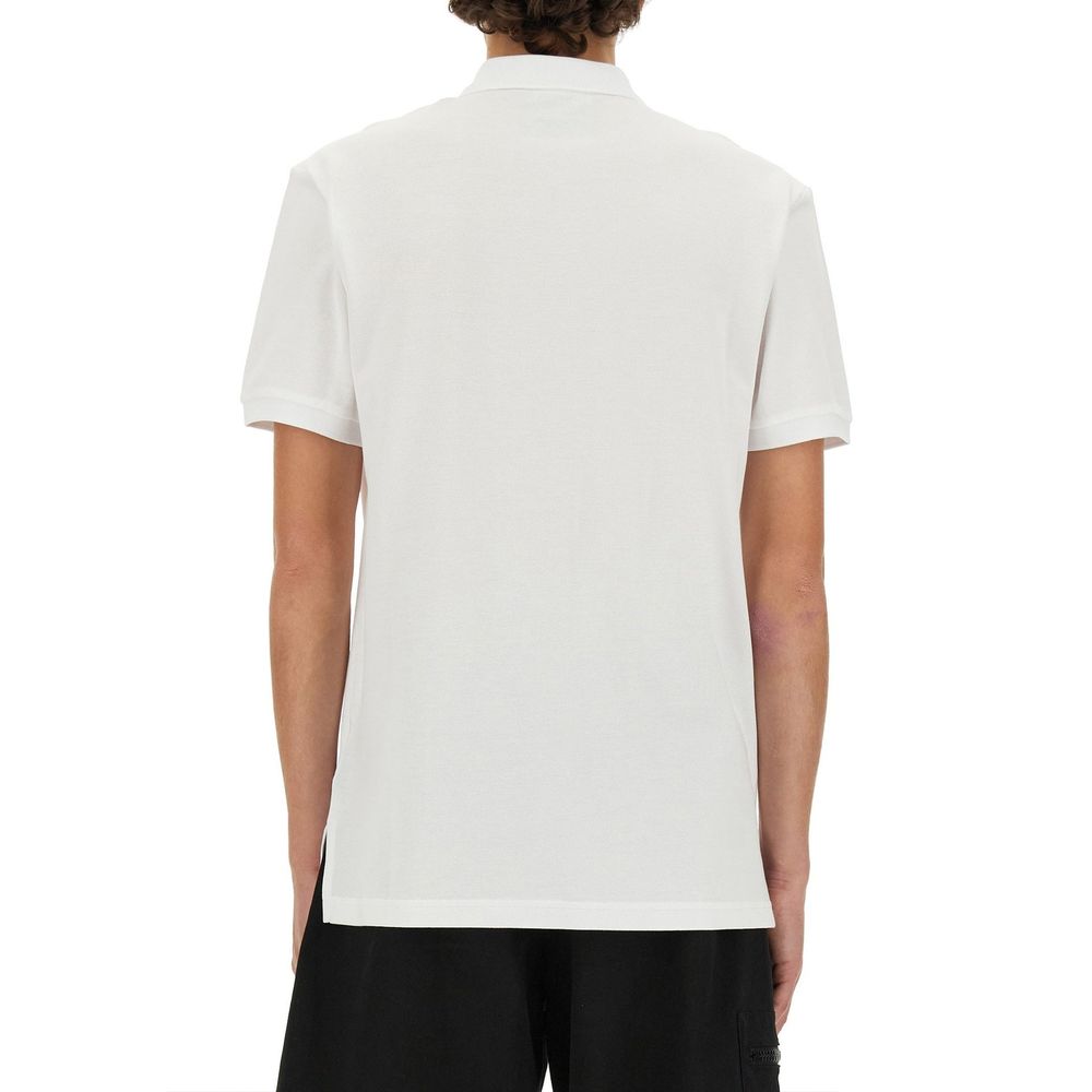 Elevate your wardrobe with the Moschino Couture White Cotton Polo Shirt, a masterpiece of 100% cotton, exuding timeless elegance and playful sophistication for the discerning individual.