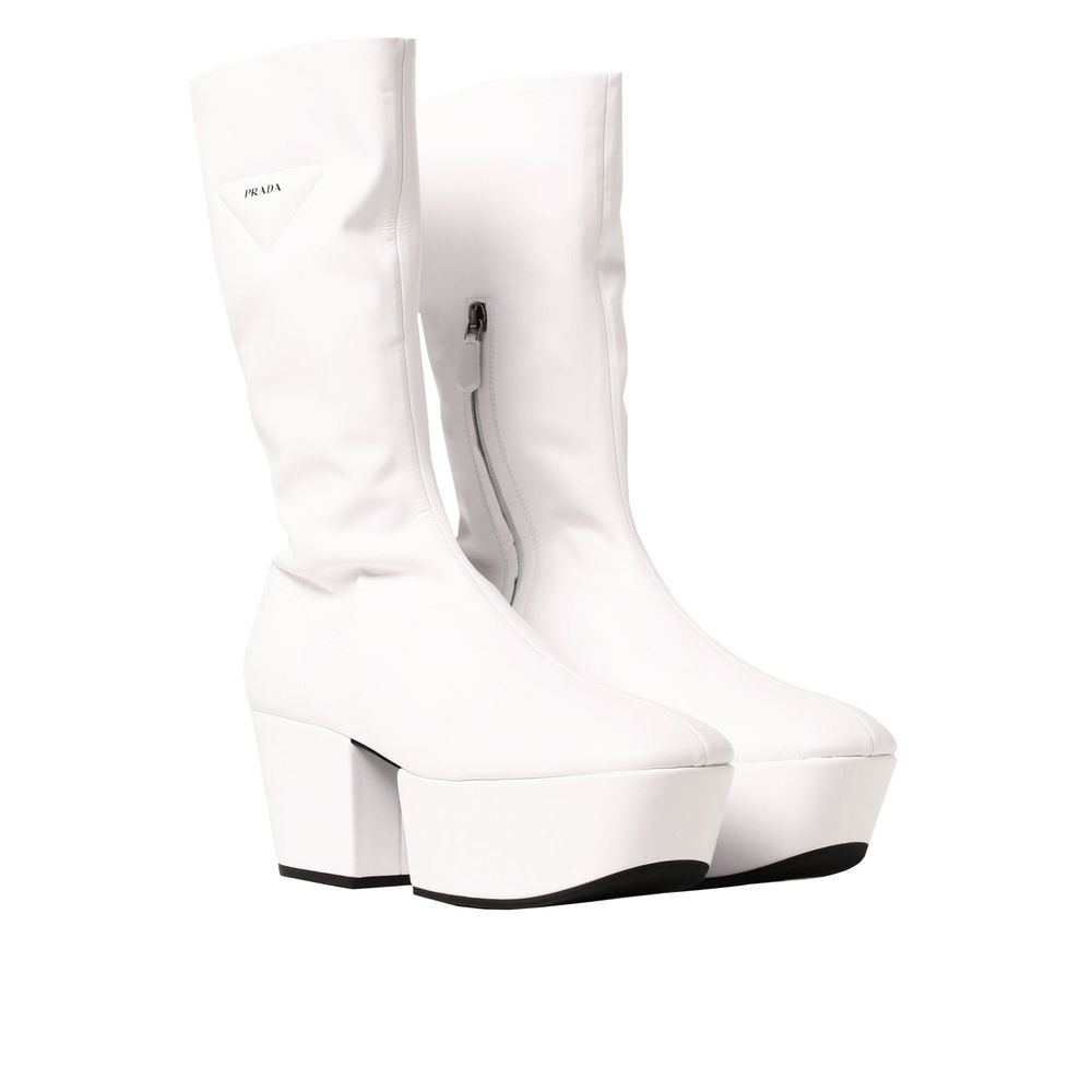 Indulge in the Prada White Polyethylene Boots, where exquisite craftsmanship meets modern luxury, elevating your style with every step in timeless elegance.