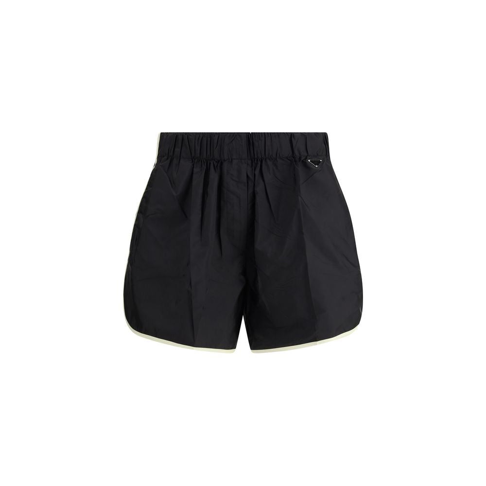 Elevate your wardrobe with Prada Black Recycled Polyamide Bermuda Shorts, a fusion of sustainable luxury and timeless elegance, crafted for the discerning individual.
