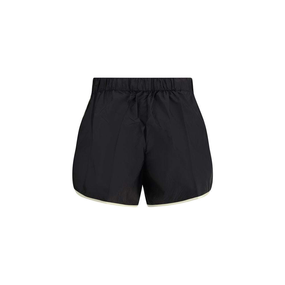 Discover the Prada Black Recycled Polyamide Bermuda Shorts, a blend of sustainable luxury and timeless elegance, crafted for the discerning individual who values style and sophistication.