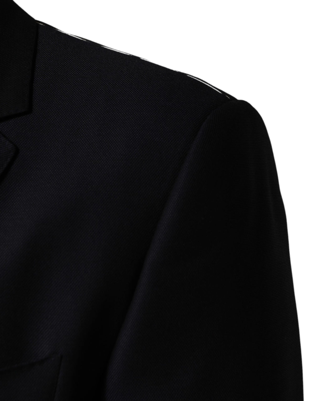 Discover the Dolce & Gabbana Black MARTINI Blazer, a sublime fusion of artisanal virgin wool and Italian craftsmanship, perfect for the discerning individual seeking timeless elegance.
