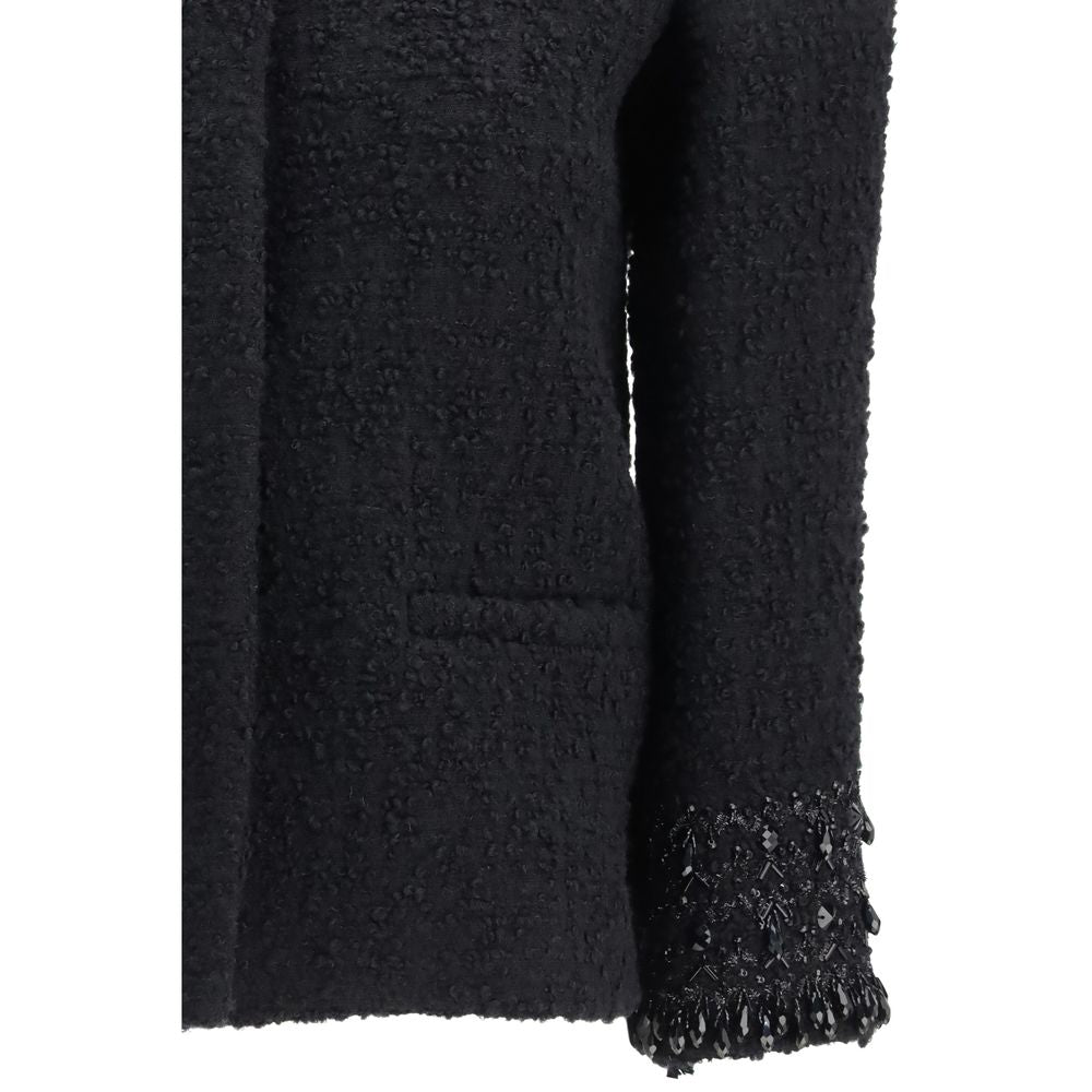 Discover the Valentino Black Fleece Wool Coat, a masterpiece of opulent craftsmanship and timeless elegance, perfect for those who embrace luxury and sophistication.