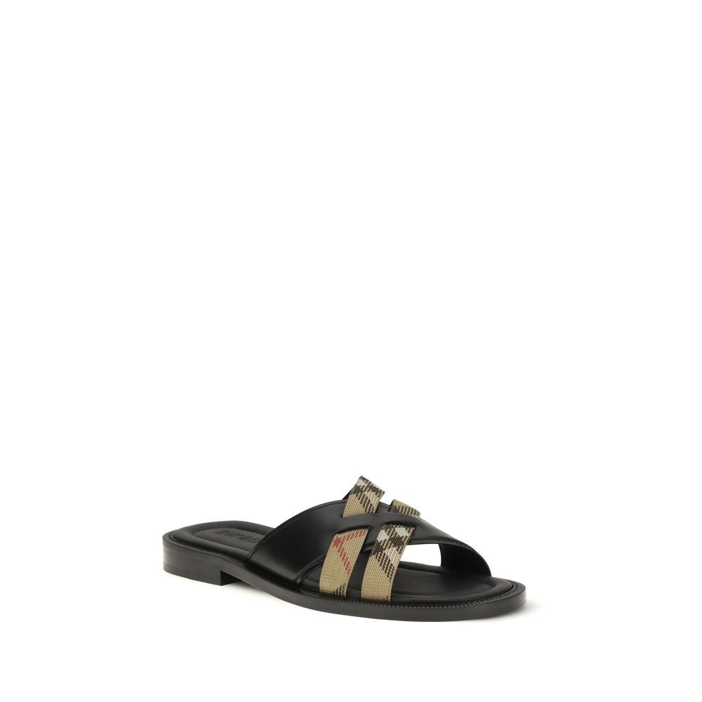 Indulge in the exquisite Burberry Black Calf Leather Bos Taurus Flat Sandals, where timeless craftsmanship meets sophisticated allure, perfect for the discerning connoisseur.