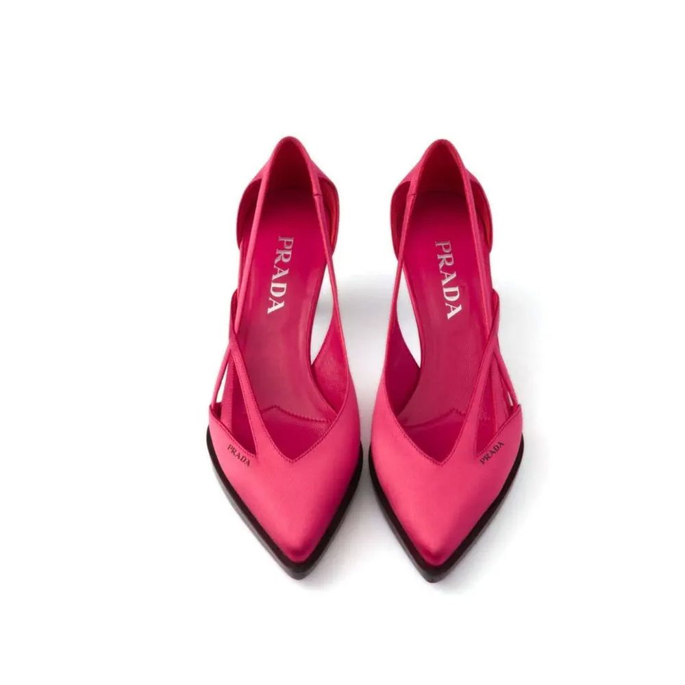 Experience the allure of Prada's Multicolor Silk Mid Heel Pumps, crafted from luxurious silk, embodying timeless elegance and sophisticated style for every occasion.