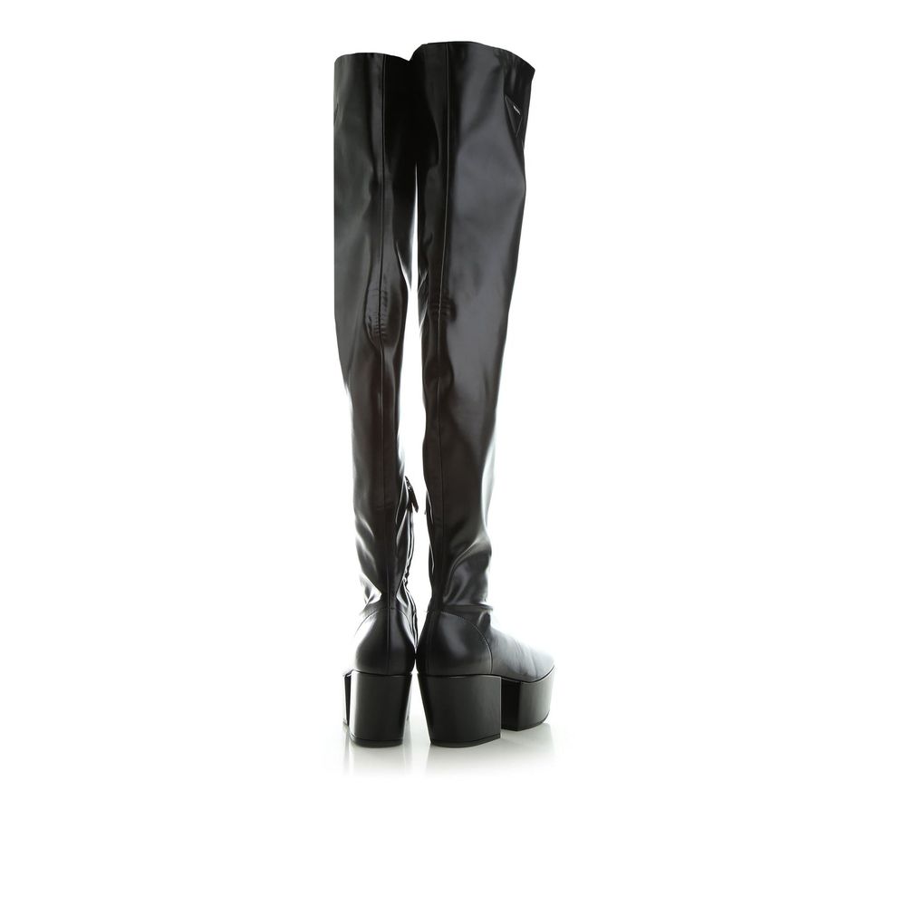 Indulge in the allure of Prada Black Calfskin Over The Knee boots, where exquisite craftsmanship meets luxurious calf leather for timeless elegance and effortless sophistication.