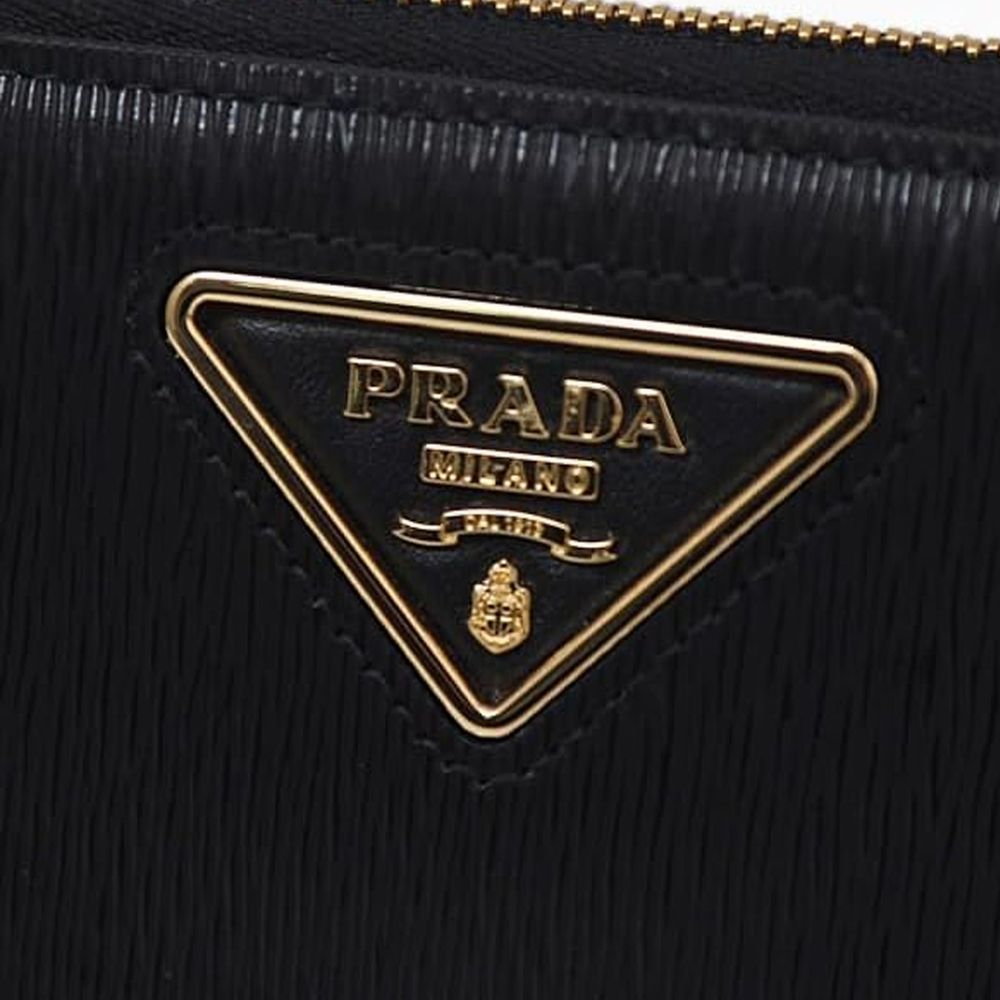 Discover the Prada Black Calfskin Wallet, a masterpiece of exquisite craftsmanship and timeless elegance, crafted from luxurious calf leather for the discerning individual.