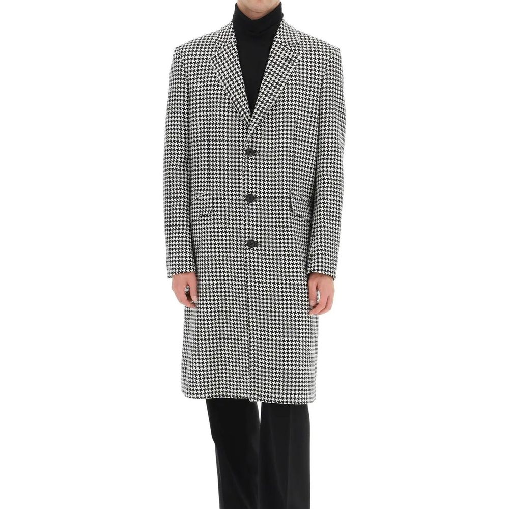 Indulge in the exquisite Alexander McQueen Black Wool Coat, a timeless masterpiece crafted from 100% premium wool, embodying sophistication and effortless elegance.