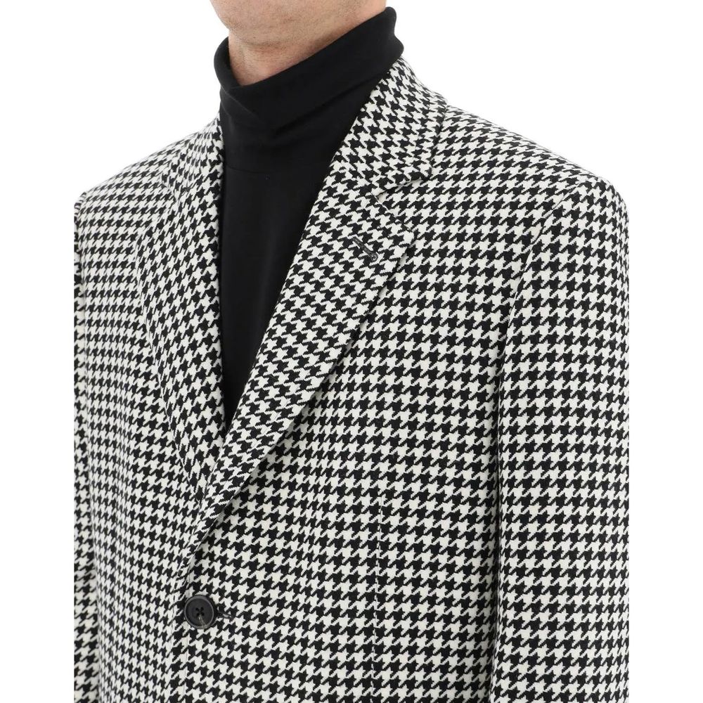 Indulge in the Alexander McQueen Black Wool Coat, a timeless masterpiece crafted from premium wool, embodying sophistication and elegance for the discerning individual.
