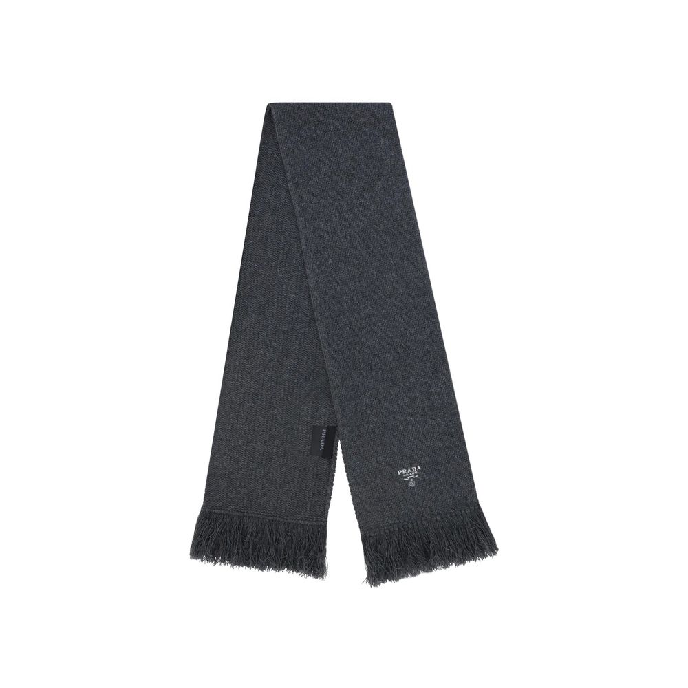 Elevate your style with the Prada Gray Cashmere Scarf, a masterpiece of Italian craftsmanship that embodies timeless luxury and sophistication for every occasion.