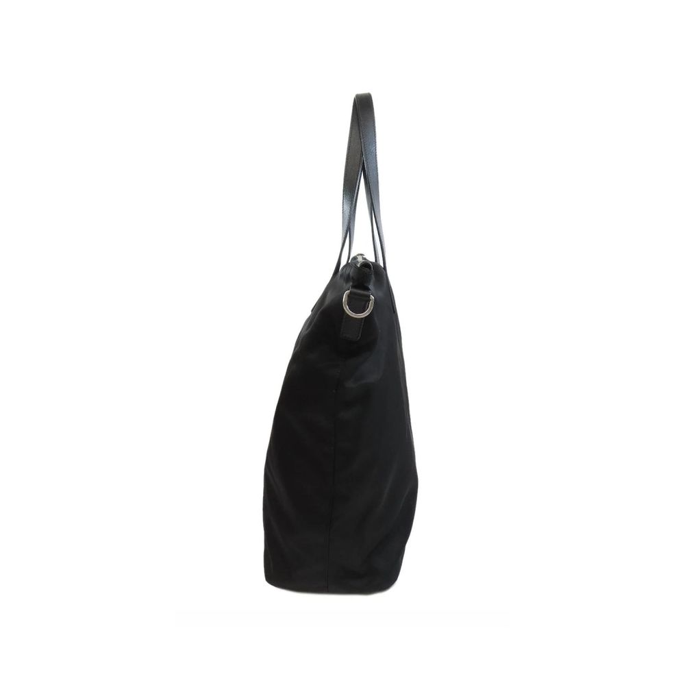 Discover the Prada Black Nylon Tote Bag, a masterpiece of exquisite craftsmanship and timeless elegance, perfect for those who embrace luxury in every moment.