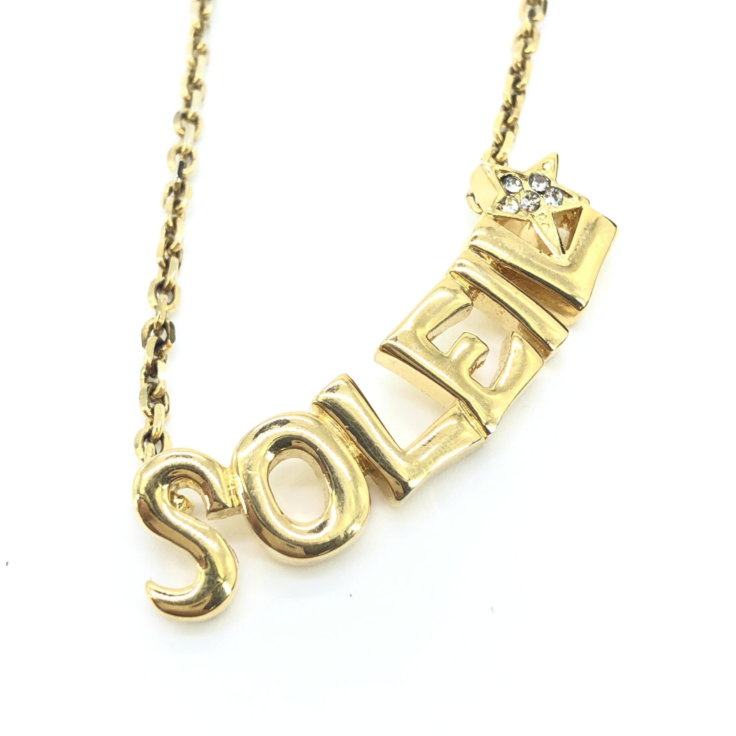 Elevate your elegance with the Yves Saint Laurent Soleil Designer Statement Necklace, a luxurious blend of gold-tone metal and radiant rhinestones, crafted in France for timeless allure.