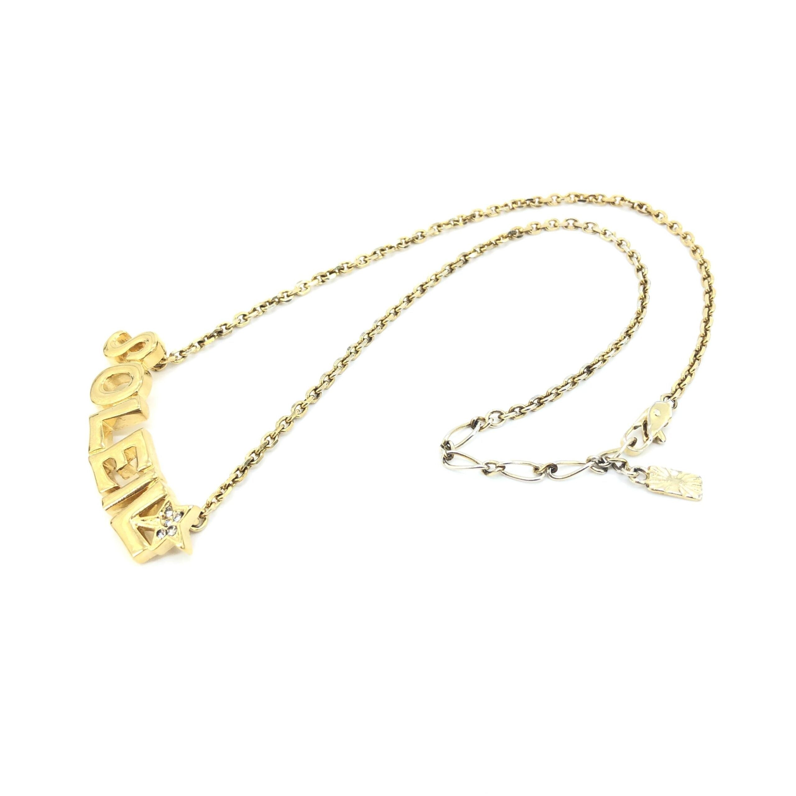 Indulge in the Yves Saint Laurent Soleil Designer Statement Necklace, a luxurious blend of gold-tone metal and radiant rhinestones, embodying timeless elegance and exquisite craftsmanship.