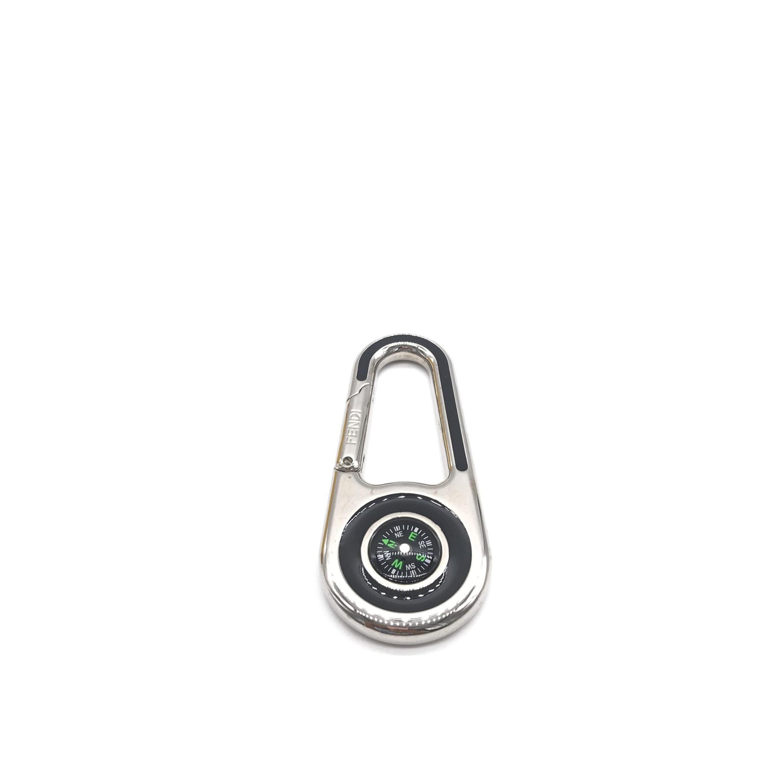 Elevate your style with the Fendi Silver Metal Compass Charm Keychain, a symbol of luxury and exquisite craftsmanship, perfect for life's sophisticated journeys.