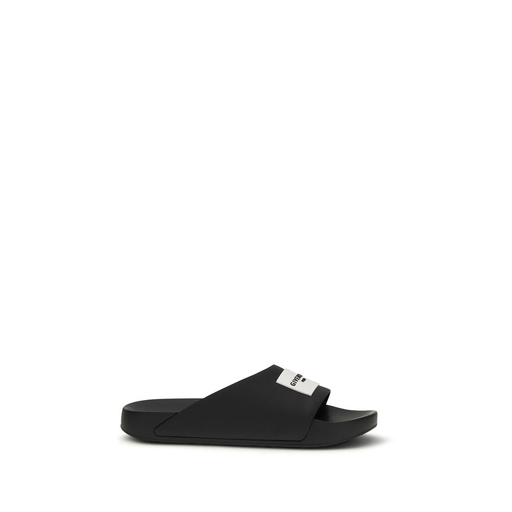 Step into a realm of refined luxury with Givenchy Black Rubber Sandals, crafted from premium rubber, blending bold design with everyday elegance for the discerning individual.