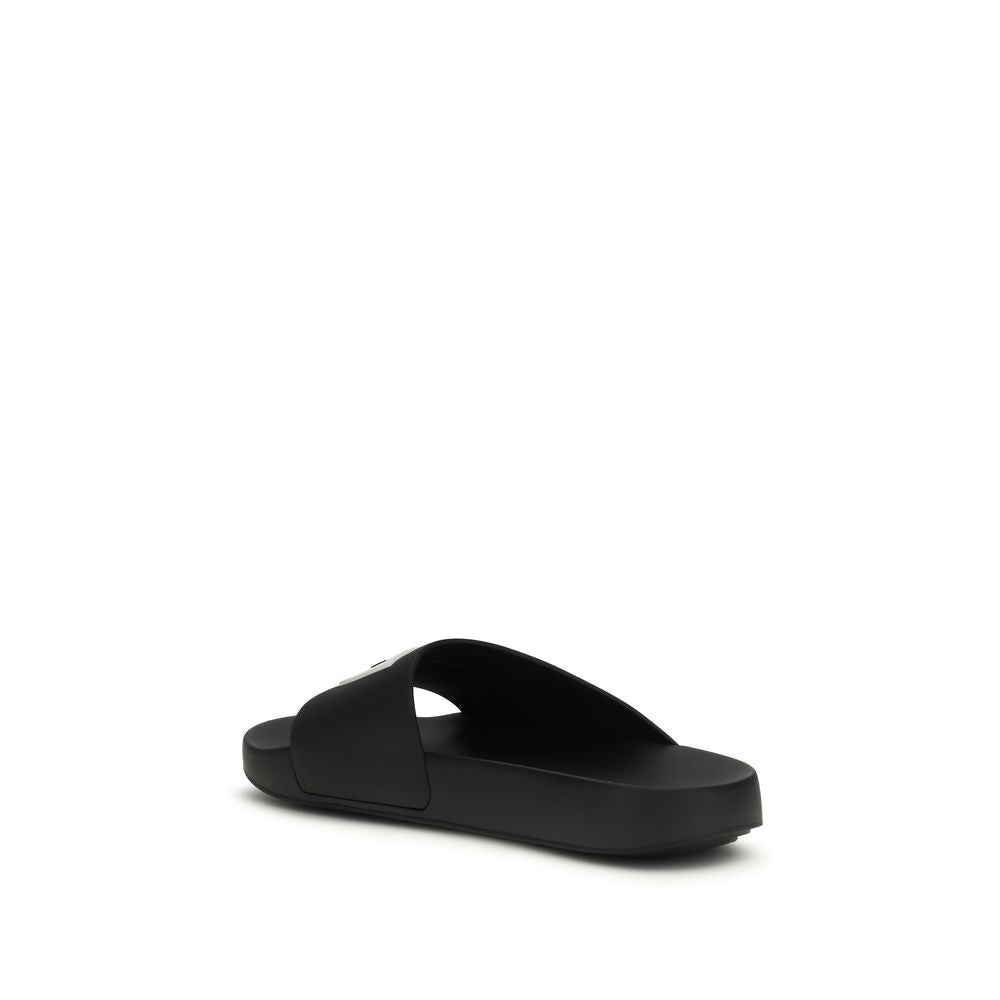 Step into the realm of luxury with Givenchy Black Rubber Sandals, where bold design meets exquisite comfort, perfect for elevating your summer elegance.