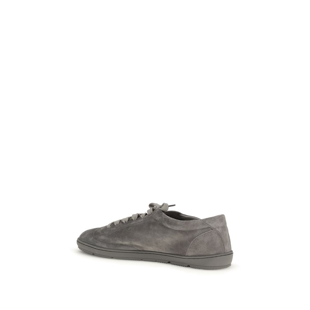 Experience unparalleled luxury with Brunello Cucinelli Gray Calf Leather Bos Taurus Low Top Sneakers, meticulously handcrafted for timeless sophistication and exceptional comfort.