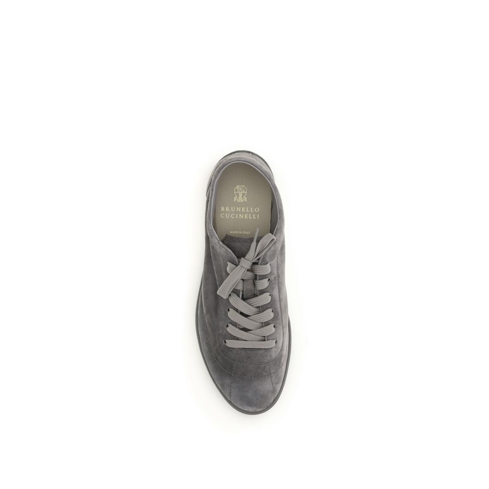 Experience unparalleled luxury with Brunello Cucinelli Gray Calf Leather Bos Taurus Low Top Sneakers, meticulously handcrafted for exquisite comfort and timeless sophistication.