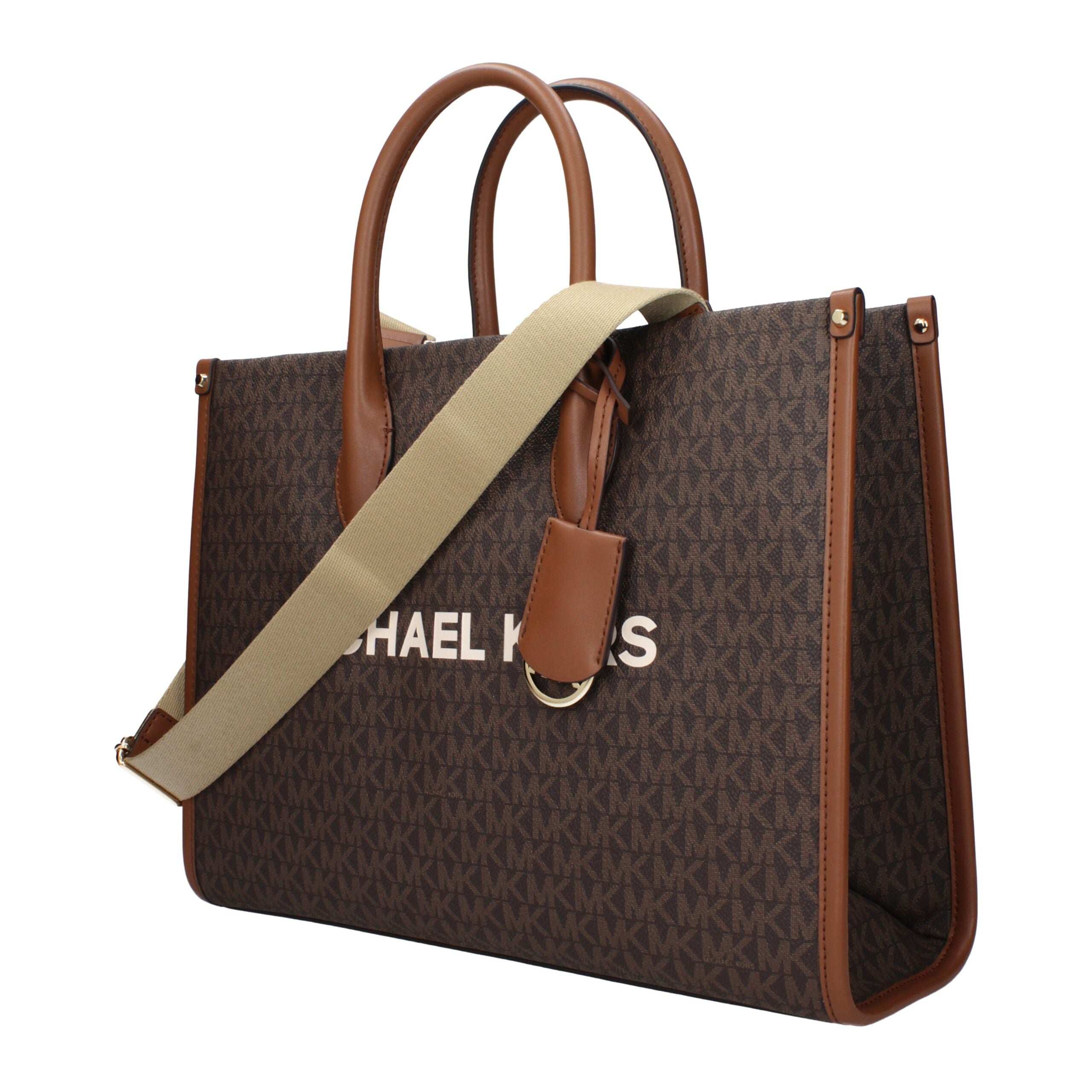 Elevate your style with the Michael Kors Brown Fabric Handbag, a luxurious blend of elegance and versatility, perfect for the discerning individual who embodies sophistication.