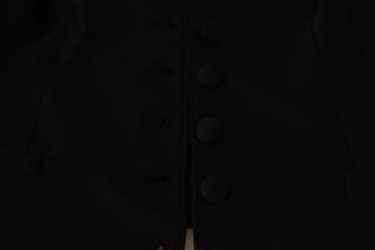 Elevate your wardrobe with the Dolce & Gabbana Solid Black Silk Sleeveless Waistcoat, a timeless piece of Italian craftsmanship that embodies sophistication and allure.