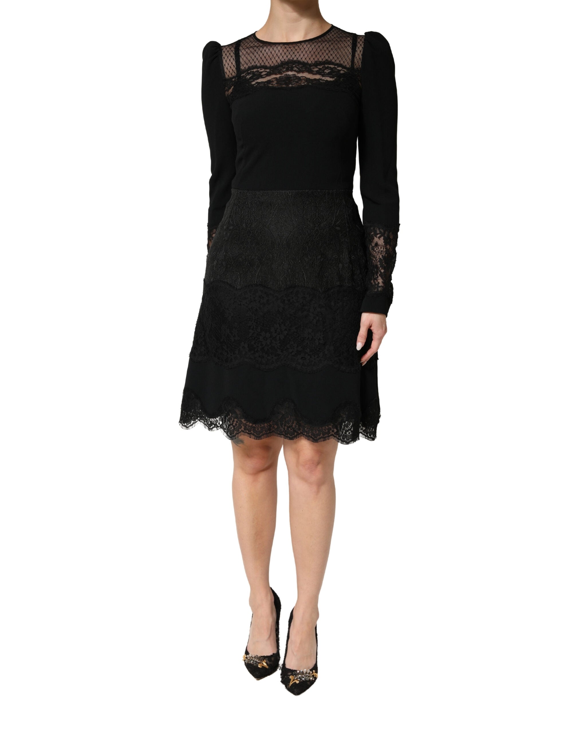 Indulge in the exquisite Dolce & Gabbana Black Lace Sheer Panel Midi Dress, where Italian craftsmanship meets luxurious materials for timeless elegance and allure.