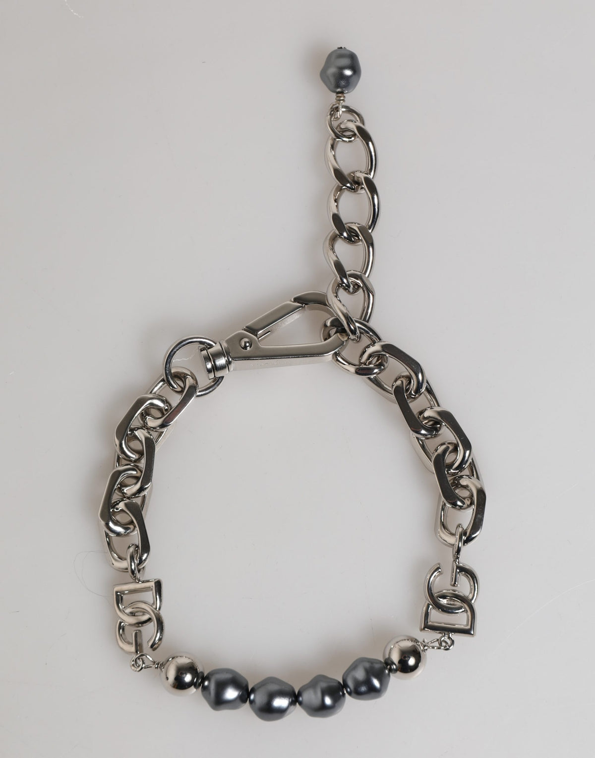 Elevate your style with the Dolce & Gabbana Silver Tone Chain Bracelet, a masterpiece of Italian craftsmanship adorned with dark-hued pearls, embodying modern luxury and allure.