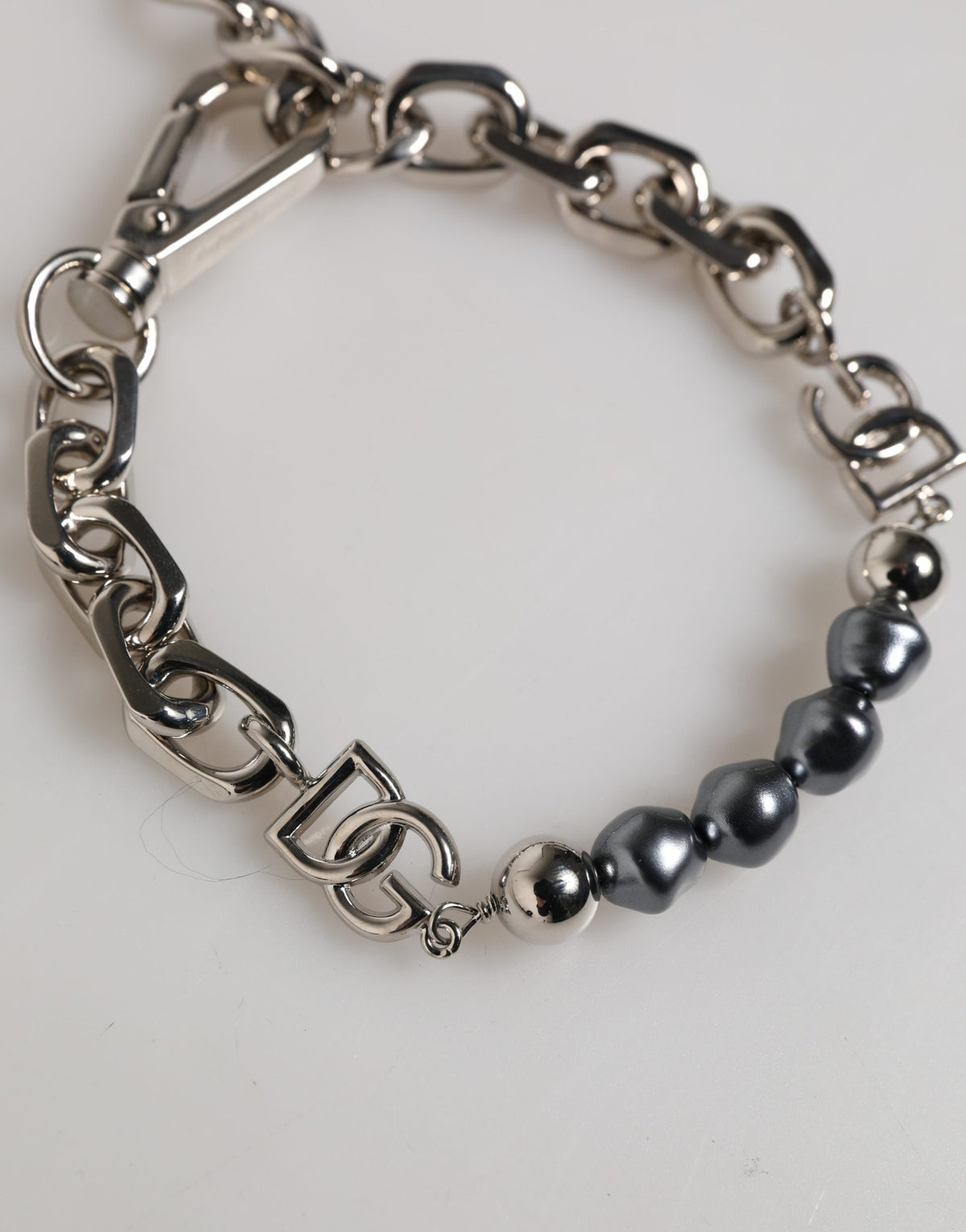 Elevate your elegance with the Dolce & Gabbana Silver Tone Chain Bracelet, a masterpiece of Italian craftsmanship adorned with dark-hued pearls, perfect for any occasion.