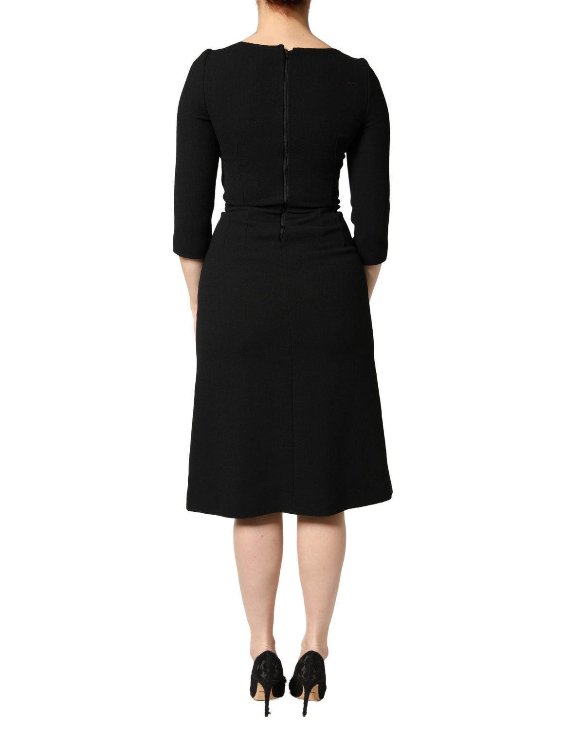 Indulge in the exquisite allure of the Dolce & Gabbana Black Wool Sacred Heart Patch Midi Dress, a masterpiece of Italian craftsmanship that embodies timeless elegance and sophistication.