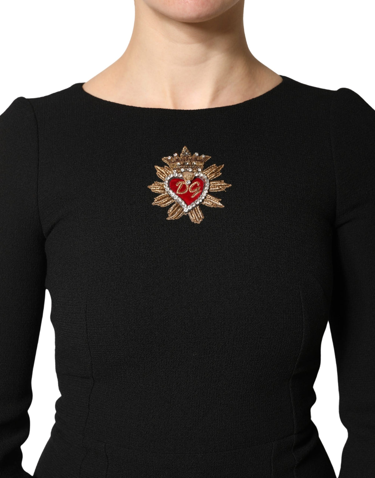 Indulge in the Dolce & Gabbana Black Wool Sacred Heart Patch Midi Dress, where exquisite craftsmanship meets timeless elegance, perfect for unforgettable moments.