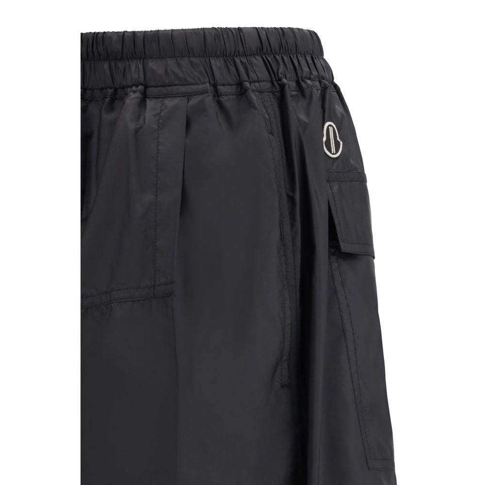 Elevate your wardrobe with the Moncler x Rick Owens Black Polyester Bermuda Shorts, where avant-garde design meets impeccable craftsmanship for timeless luxury.