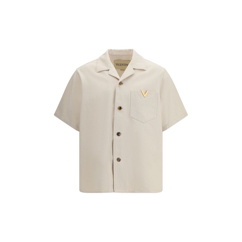 Discover the Valentino Beige Denim Shirt, a masterpiece of 100% cotton luxury, blending casual elegance with distinctive V GOLD details for the discerning individual.