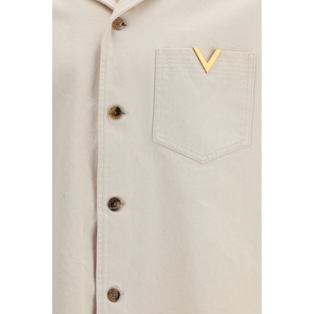 Experience the exquisite luxury of the Valentino Beige Denim Shirt, crafted from 100% cotton, where casual elegance meets iconic artistry for the discerning individual.