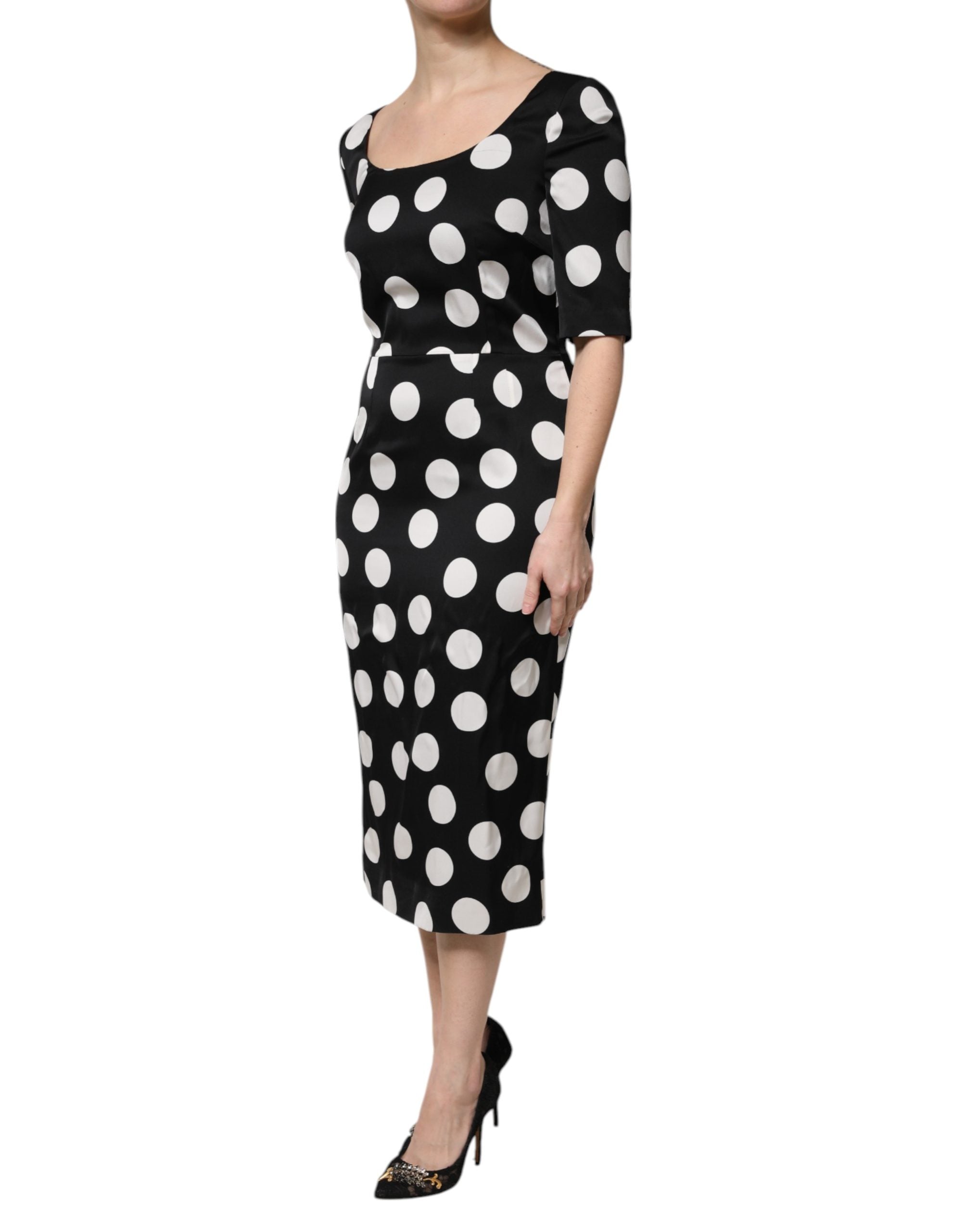 Discover the Dolce & Gabbana Black White Polka Dot Silk Sheath Midi Dress, a masterpiece of Italian craftsmanship that embodies timeless elegance and versatility for the discerning individual.