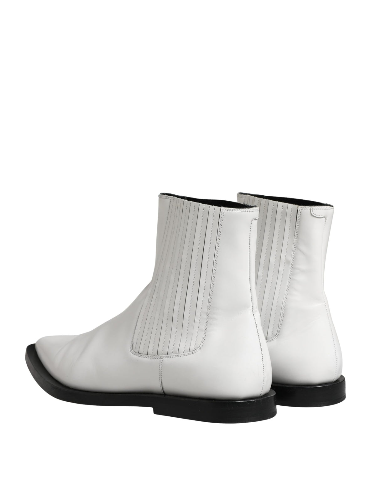 Indulge in the exquisite allure of Dolce & Gabbana's white leather ankle boots, where Italian craftsmanship meets timeless elegance, perfect for any sophisticated occasion.