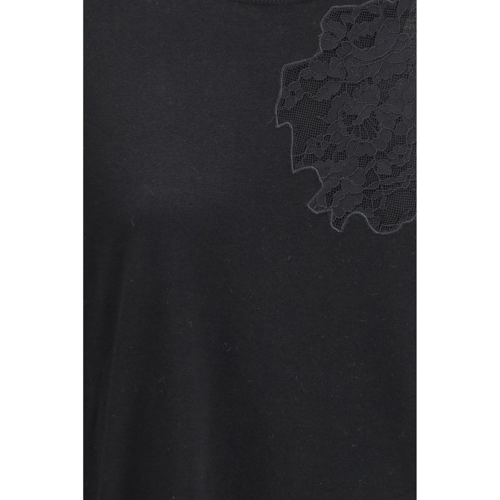 Indulge in the Max Mara Black Silk Sweatshirt, a luxurious blend of silk and wool, featuring delicate lace inserts for timeless elegance and sophisticated allure.