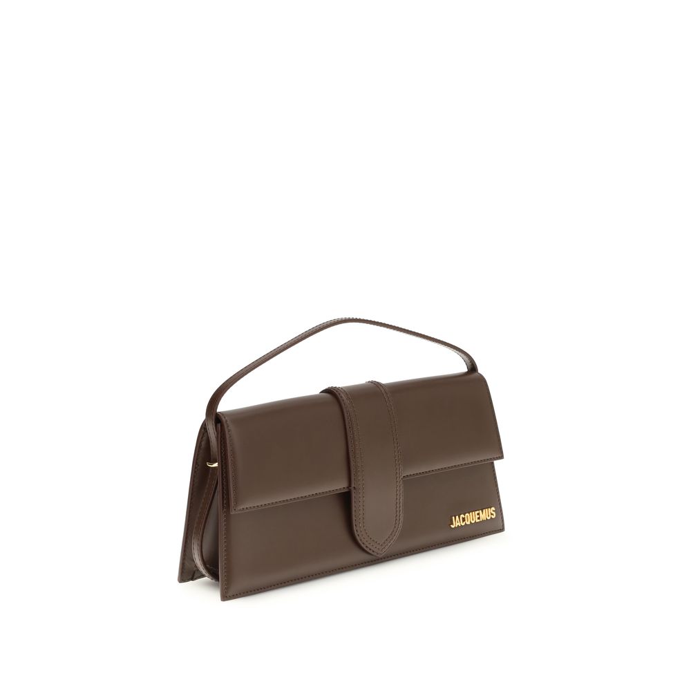 Indulge in the Jacquemus Brown Calf Leather Bos Taurus Shoulder Bag, where exquisite glacé leather meets timeless elegance, embodying luxury and sophistication for the discerning connoisseur.