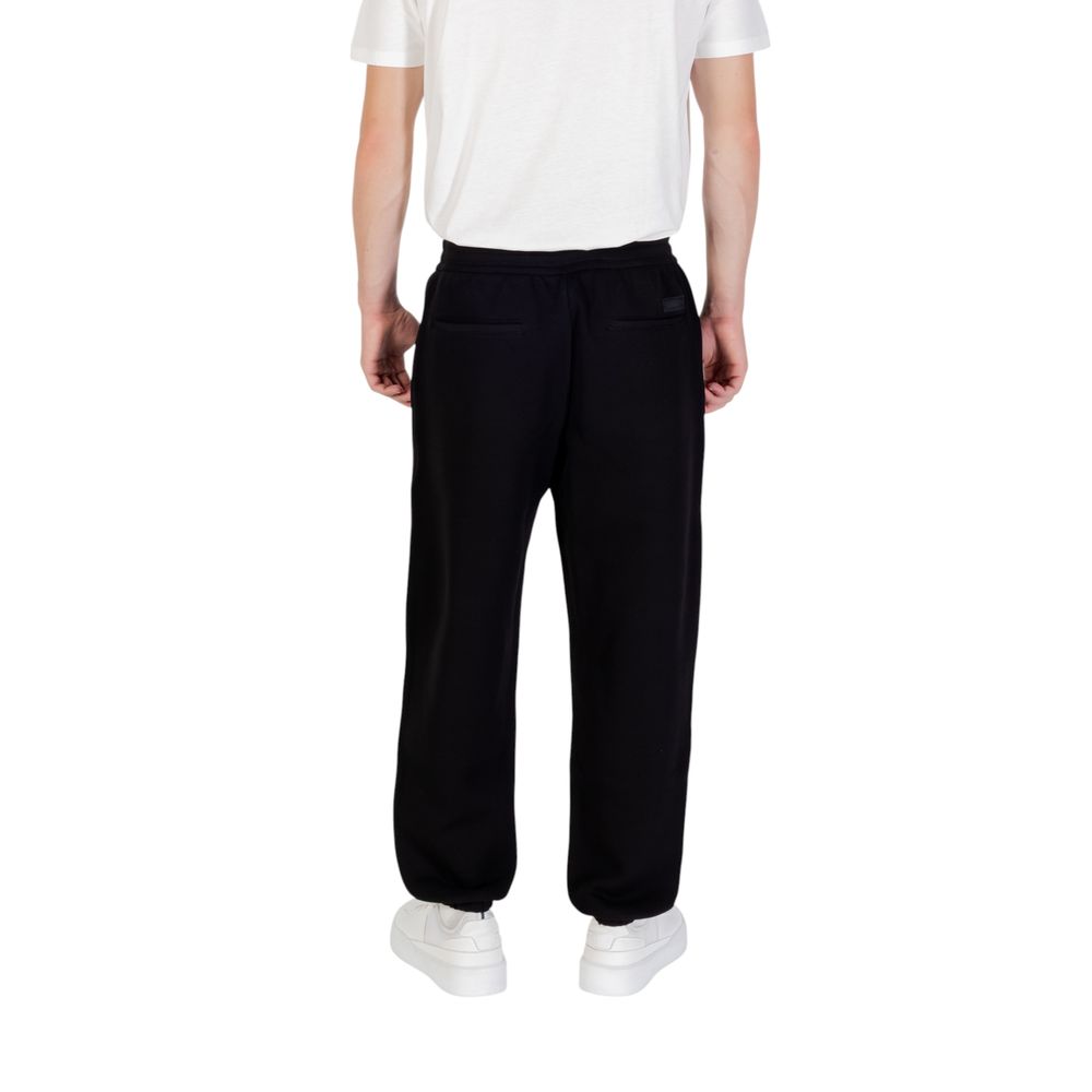 Indulge in the luxurious allure of Armani Exchange Black Cotton Joggers, crafted for effortless elegance and versatile comfort in every sophisticated setting.
