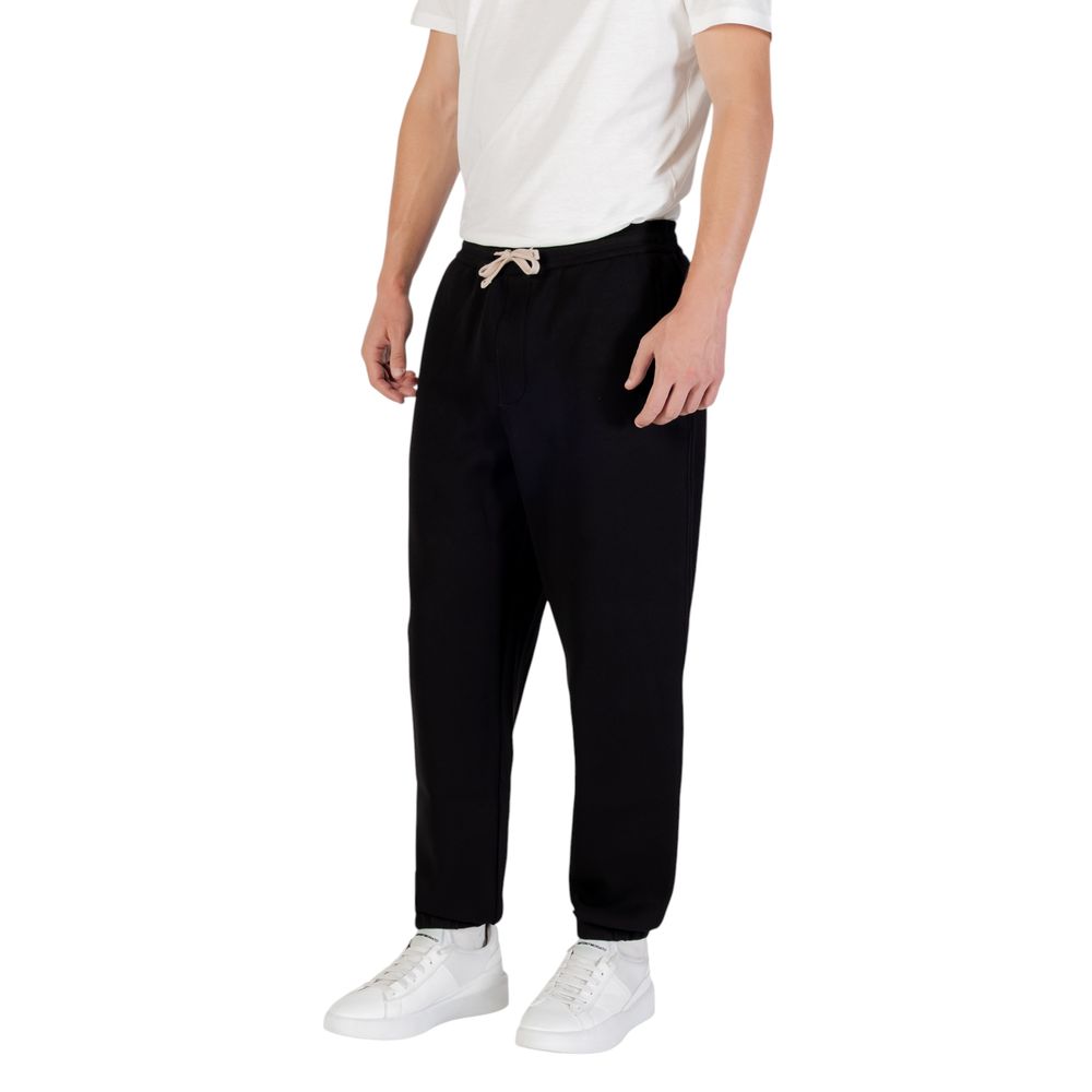 Elevate your wardrobe with Armani Exchange Black Cotton Joggers, crafted from a luxurious blend for unparalleled comfort and effortless elegance in every moment.