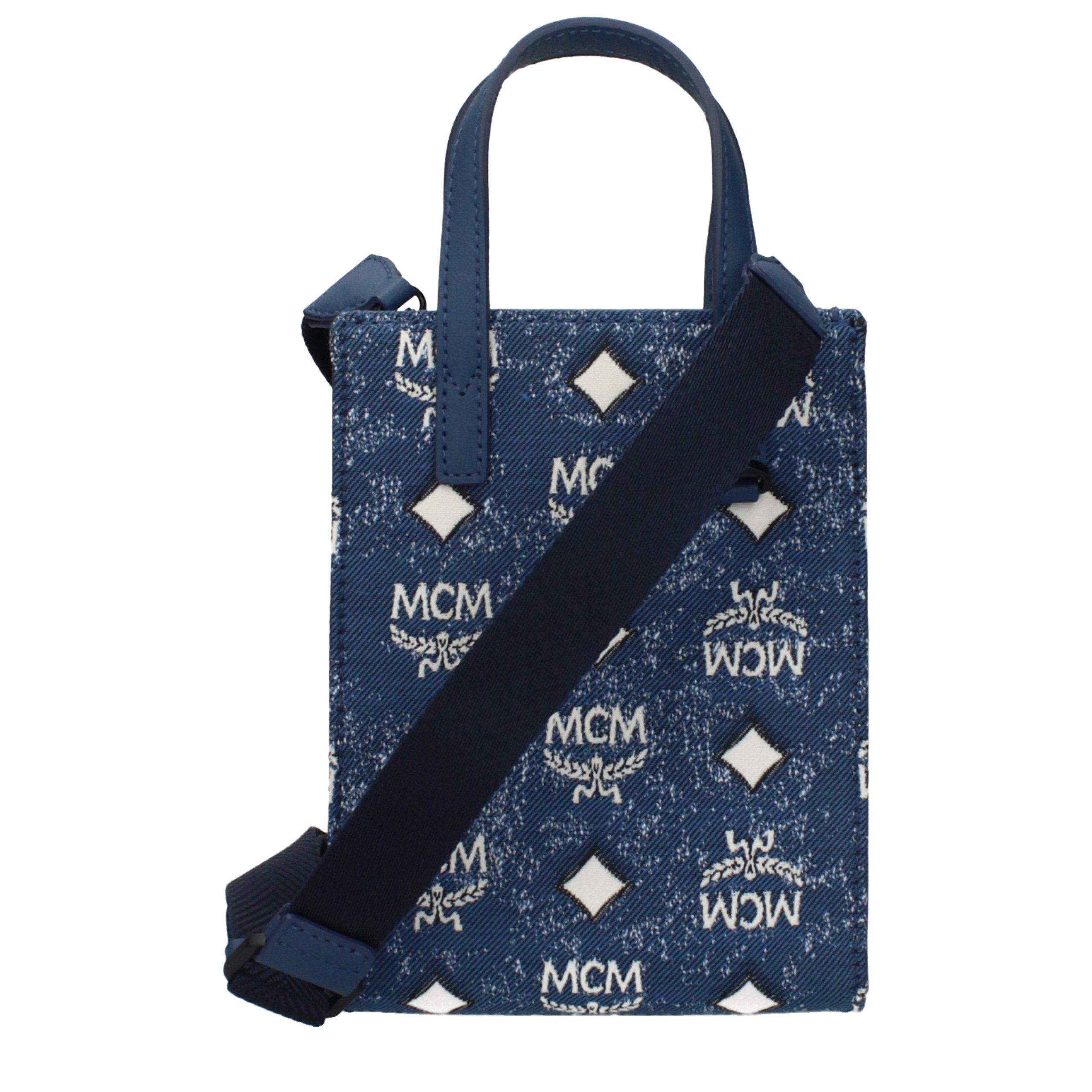 Elevate your elegance with the MCM Blue Fabric Handbag, a luxurious blend of sophistication and versatility, perfect for those who appreciate timeless style.