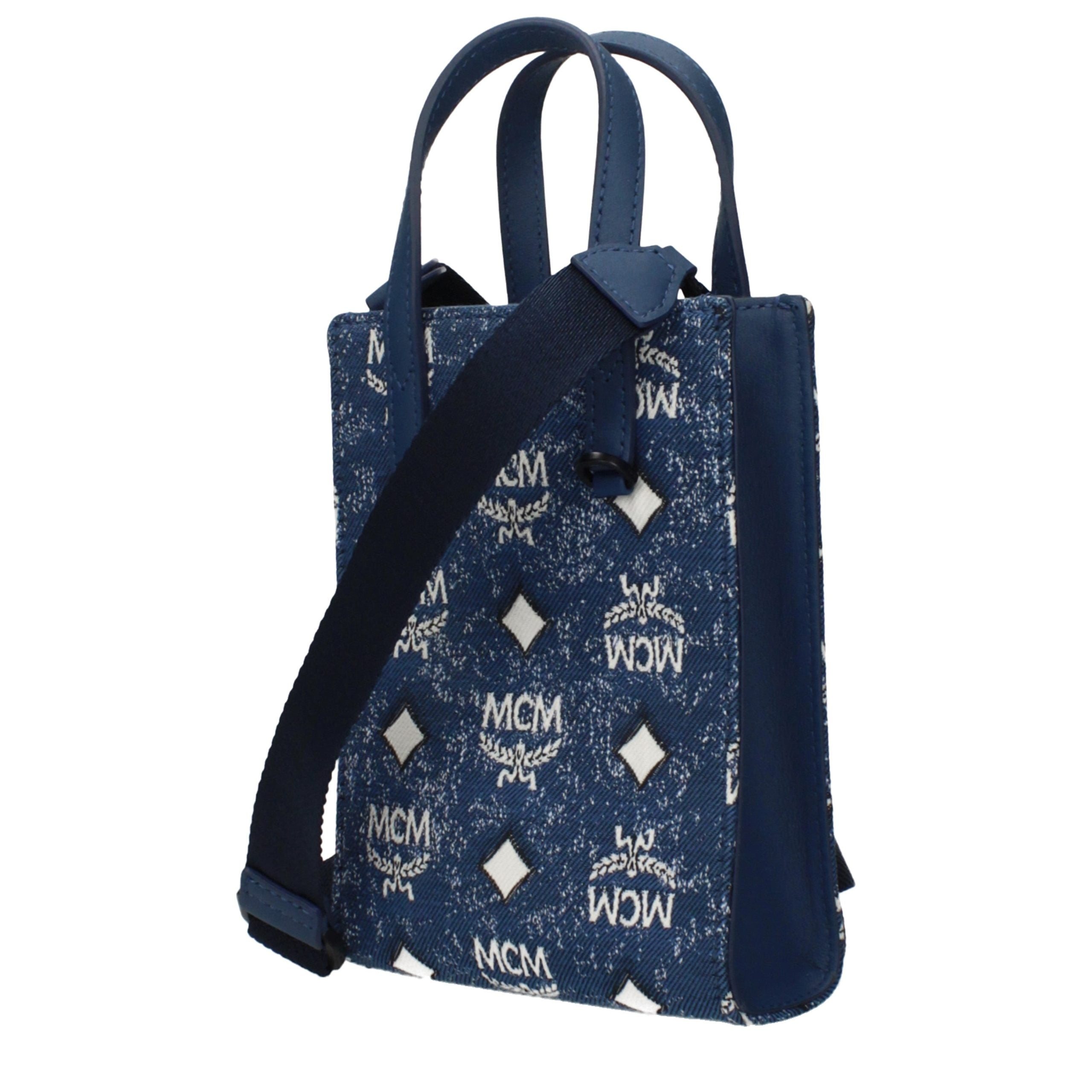 Elevate your elegance with the MCM Blue Fabric Handbag, a luxurious blend of sophistication and versatility, perfect for the discerning individual who appreciates timeless style.