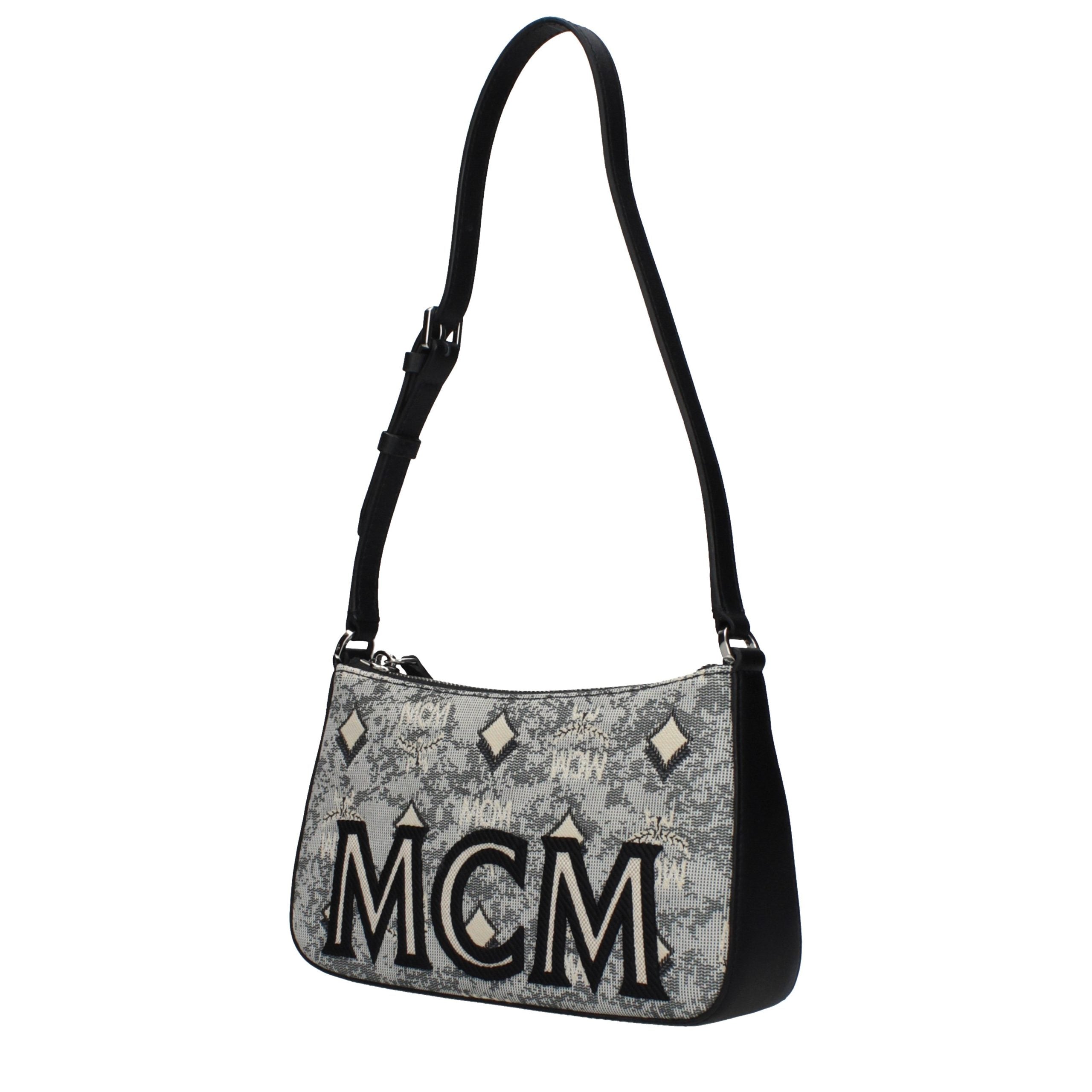 Discover the MCM Gray Fabric Crossbody Bag, a masterpiece of artisanal luxury that elevates your style with its sophisticated design and impeccable craftsmanship.
