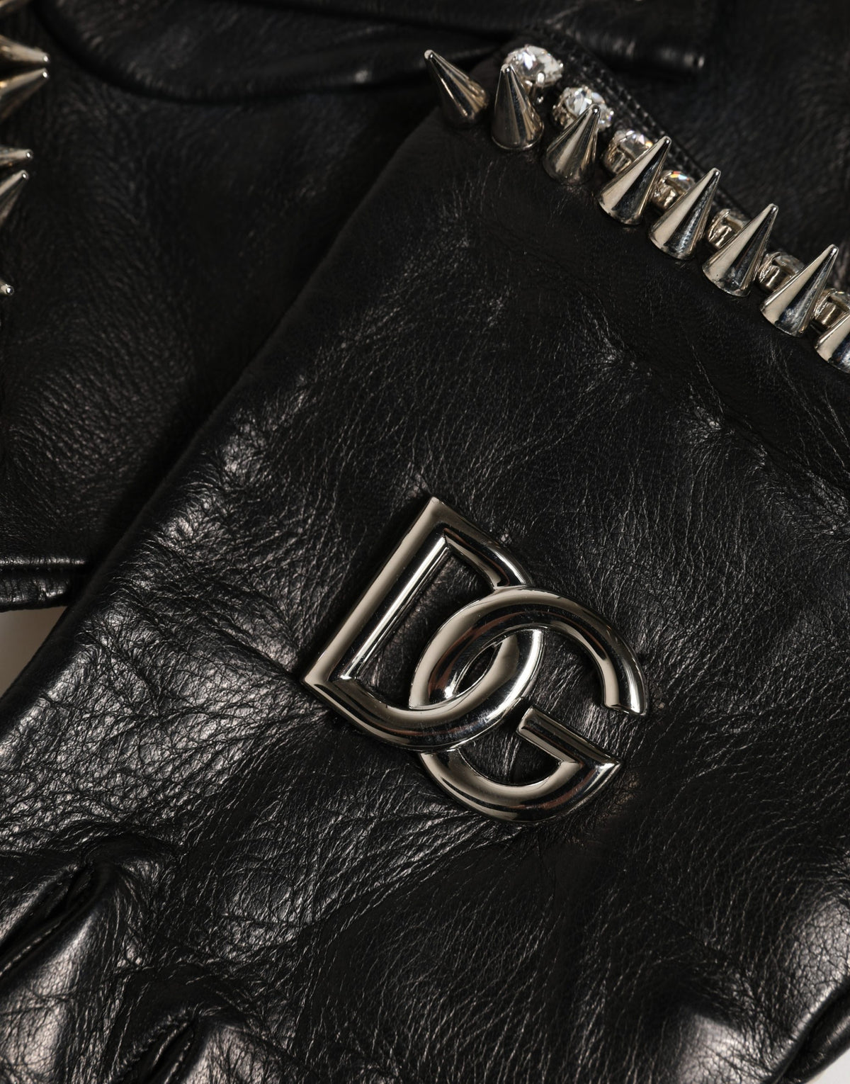Indulge in the exquisite craftsmanship of Dolce & Gabbana's Black Embellished Leather Fingerless Gloves, a luxurious accessory that elevates your winter style with timeless elegance.