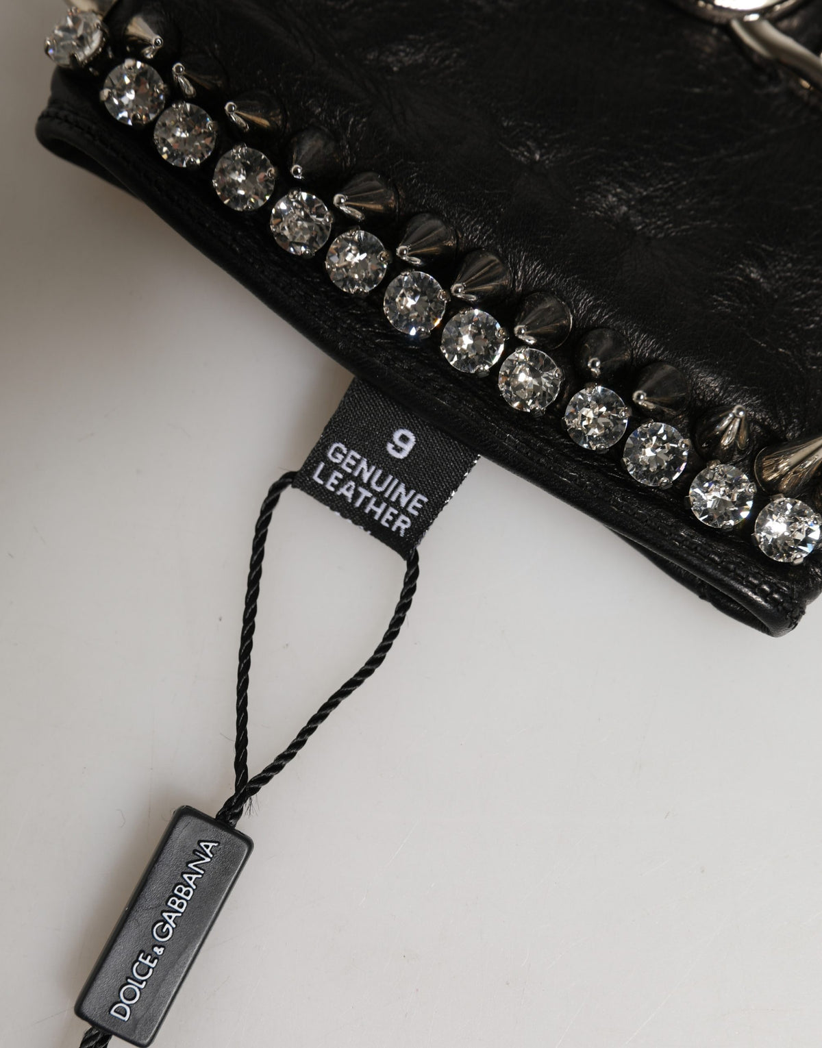 Indulge in the exquisite craftsmanship of Dolce & Gabbana's Black Embellished Leather Fingerless Gloves, a luxurious accessory that elevates your winter elegance.
