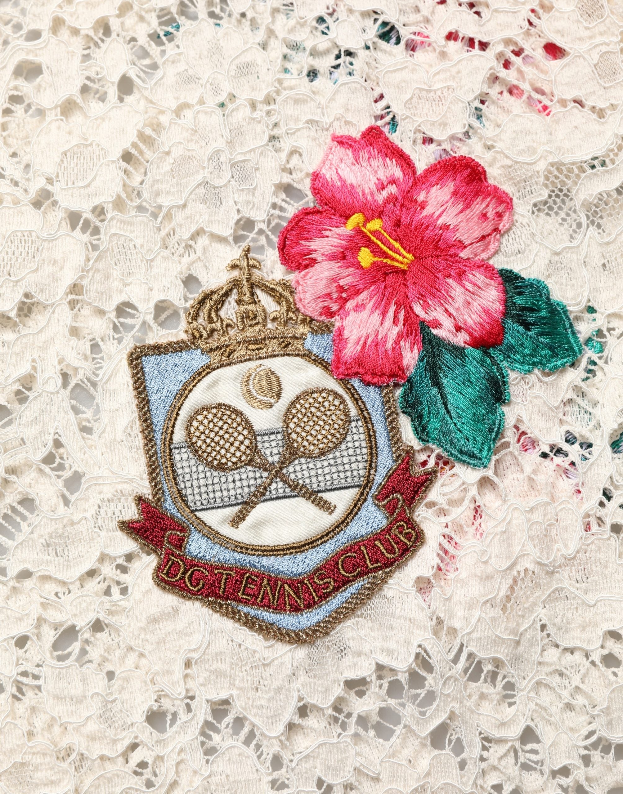 Experience the allure of Dolce & Gabbana's Beige Floral Tennis Club Lace Polo T-shirt, a blend of luxurious materials and Italian craftsmanship that redefines elegance.